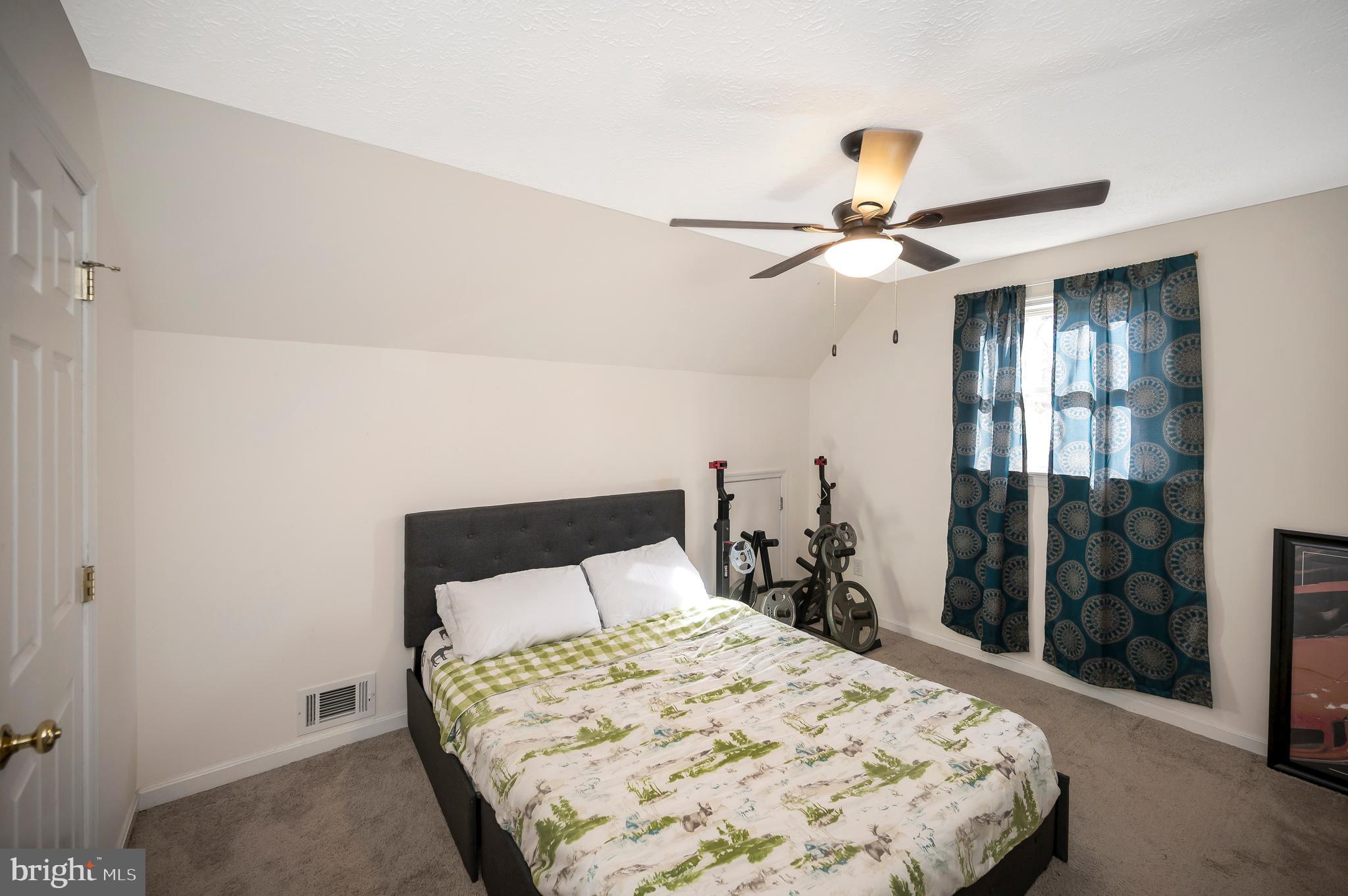 9577 Roys Lane Culpeper, VA 22701 - Photo 26 of 42 a bedroom with a bed and a chandelier