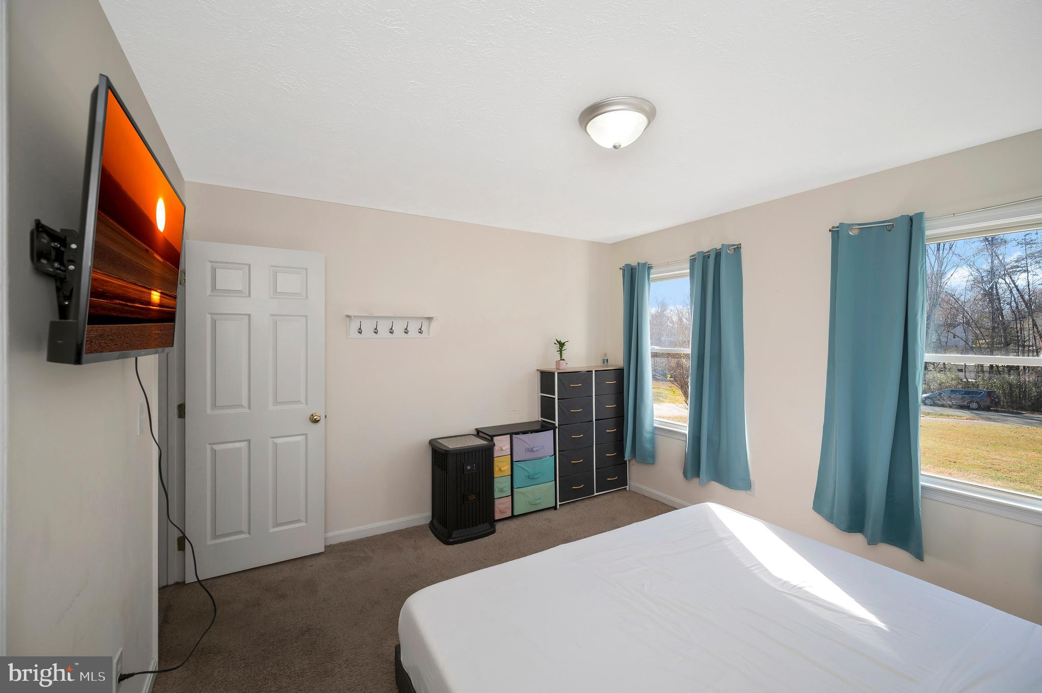 9577 Roys Lane Culpeper, VA 22701 - Photo 30 of 42 a bedroom with a bed and a flat screen tv