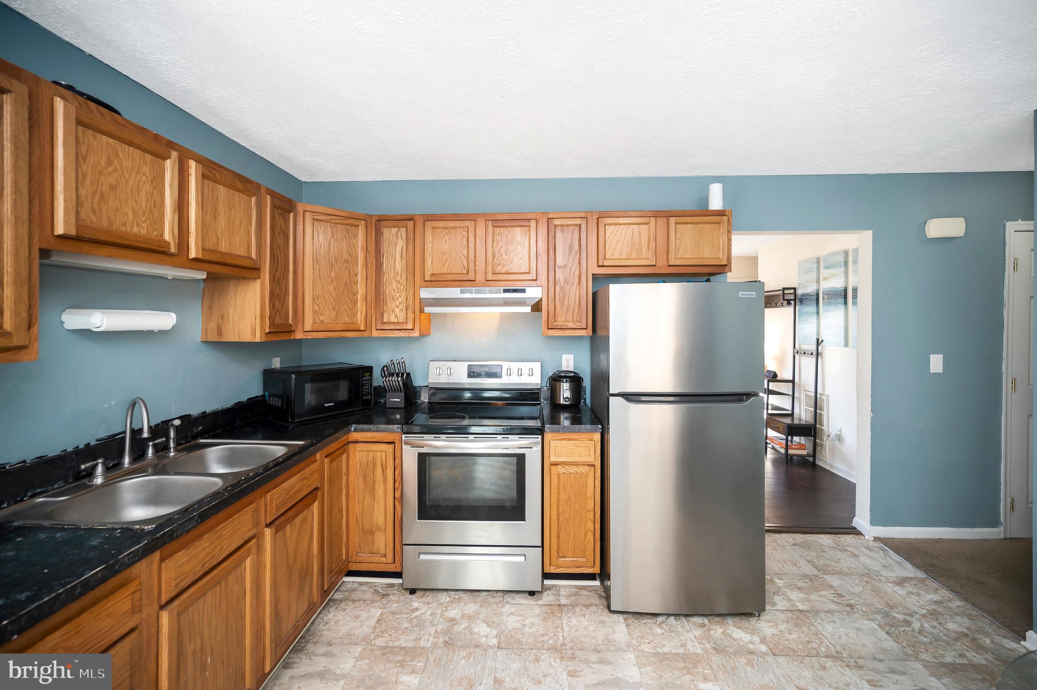 9577 Roys Lane Culpeper, VA 22701 - Photo 9 of 41 a kitchen with stainless steel appliances granite countertop a refrigerator a sink a stove a washer dryer and cabinets