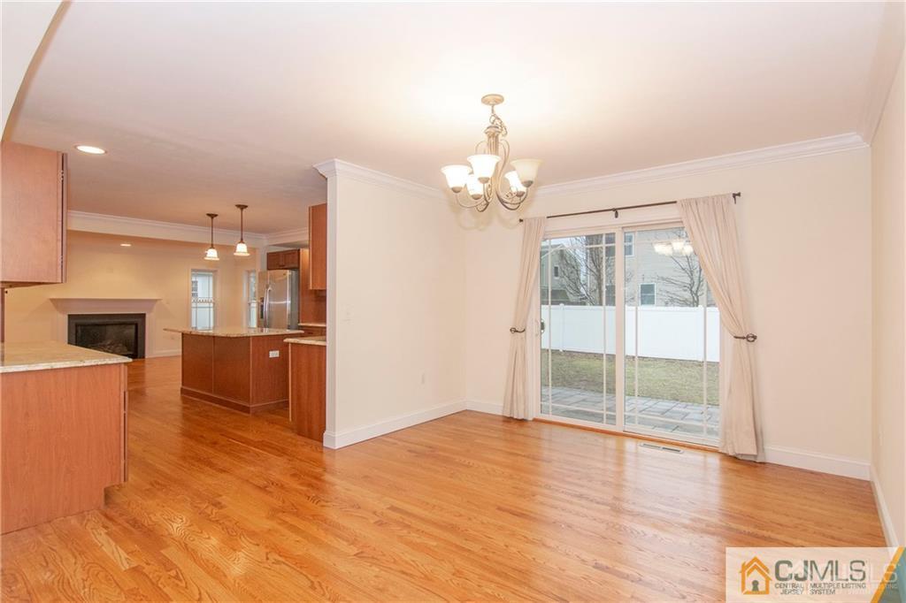 2231 Foster Road Point Pleasant, NJ 08742 - Photo 11 of 25 a view of a room with wooden floor and kitchen view