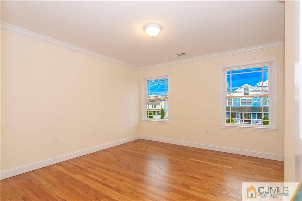 2231 Foster Road Point Pleasant, NJ 08742 - Photo 13 of 25 an empty room with wooden floor and windows
