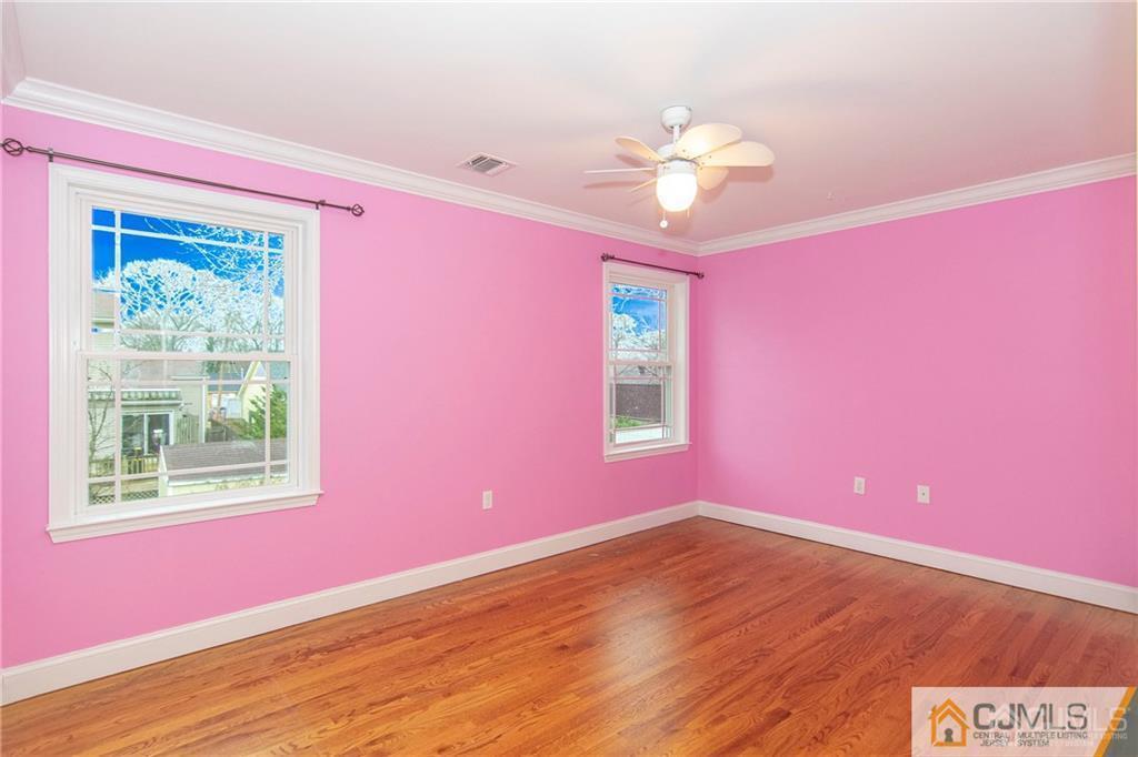2231 Foster Road Point Pleasant, NJ 08742 - Photo 14 of 25 a view of wooden floor and chandelier fan in a room
