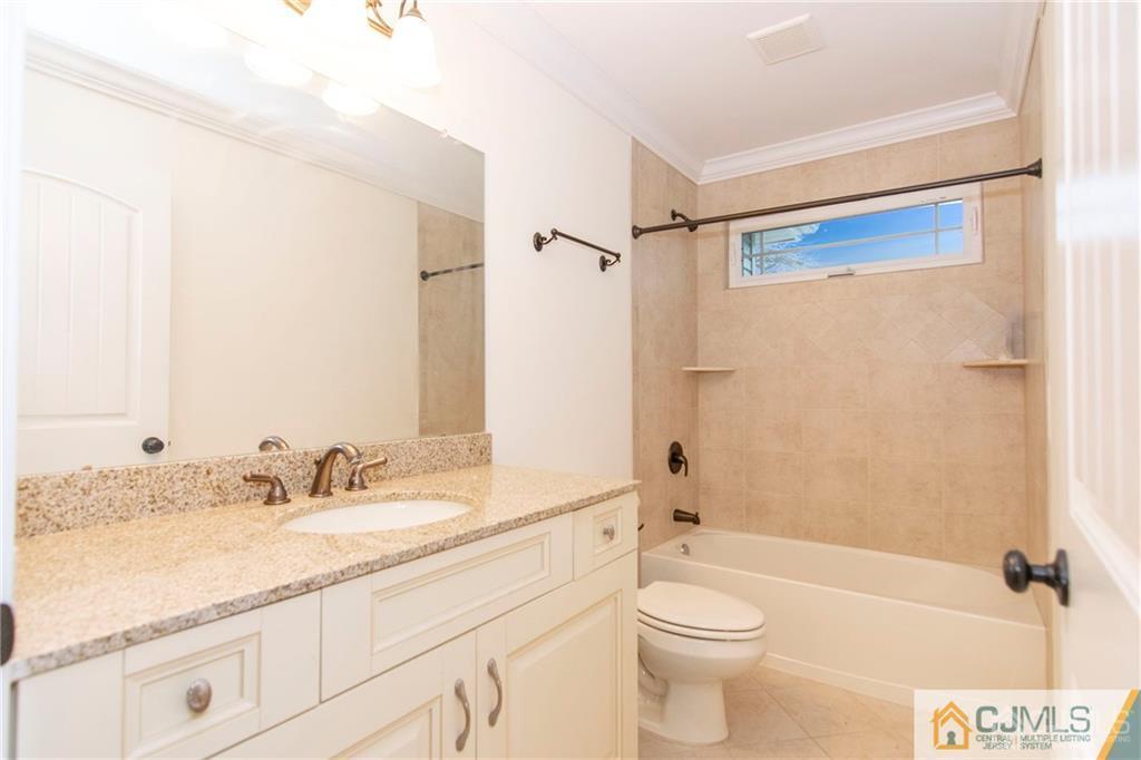 2231 Foster Road Point Pleasant, NJ 08742 - Photo 15 of 25 a bathroom with a granite countertop sink toilet and shower