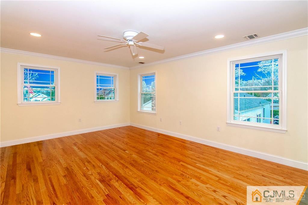 2231 Foster Road Point Pleasant, NJ 08742 - Photo 16 of 25 a view of an empty room with wooden floor and a window