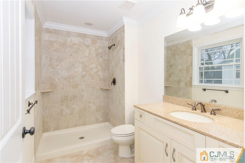 2231 Foster Road Point Pleasant, NJ 08742 - Photo 18 of 25 a bathroom with a granite countertop sink toilet and shower