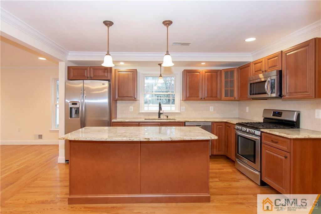 2231 Foster Road Point Pleasant, NJ 08742 - Photo 3 of 25 a kitchen with stainless steel appliances granite countertop a sink a stove and a microwave