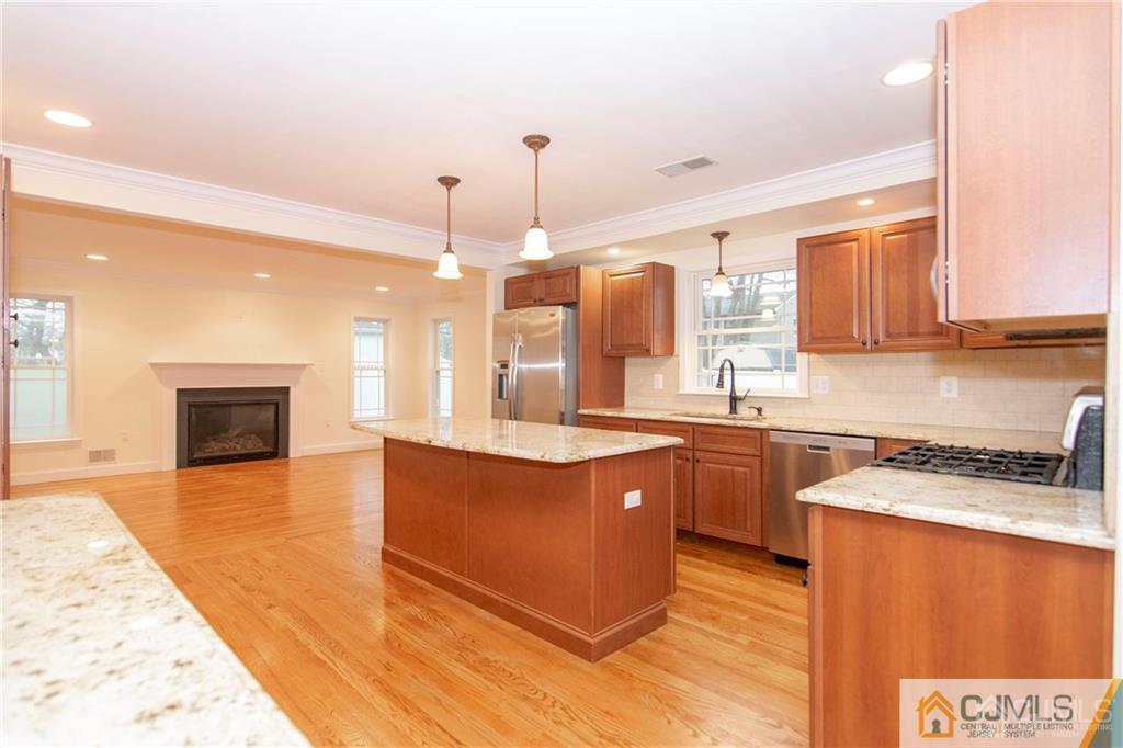 2231 Foster Road Point Pleasant, NJ 08742 - Photo 5 of 25 a kitchen with stainless steel appliances granite countertop a sink a stove top oven a counter space and cabinets