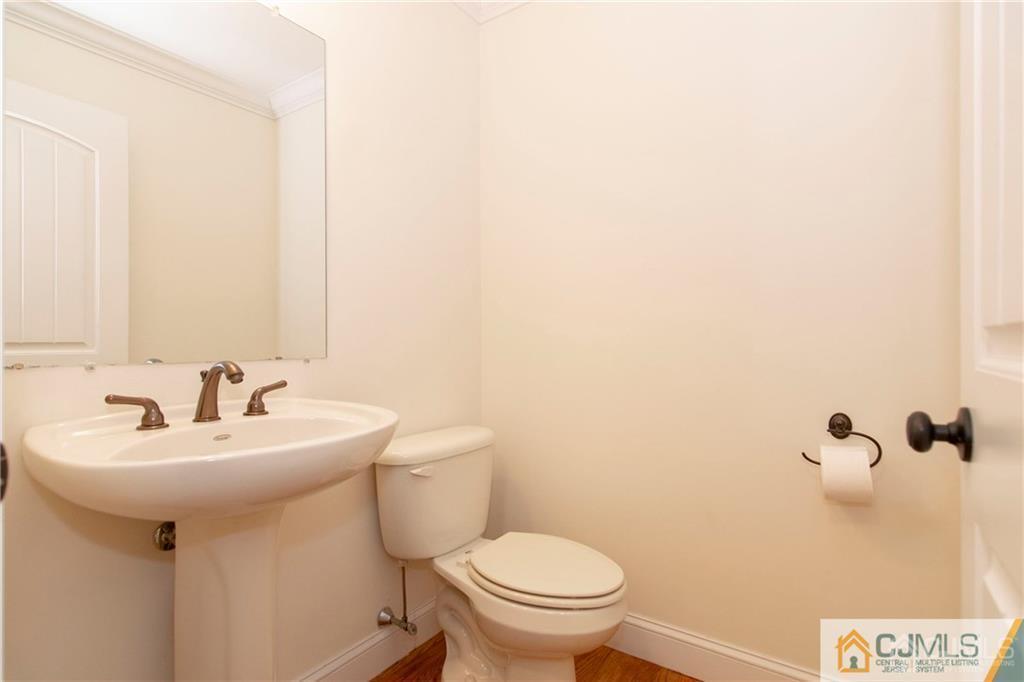 2231 Foster Road Point Pleasant, NJ 08742 - Photo 6 of 25 a bathroom with a sink a toilet and mirror