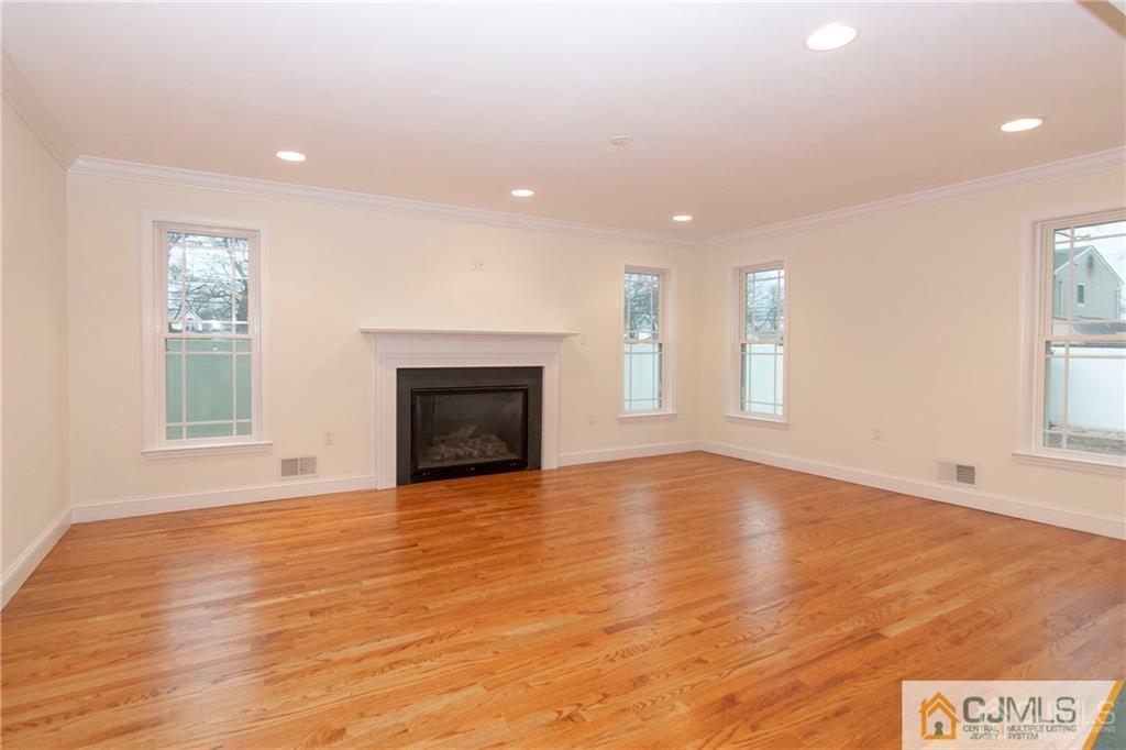 2231 Foster Road Point Pleasant, NJ 08742 - Photo 7 of 25 a view of empty room with wooden floor and fireplace