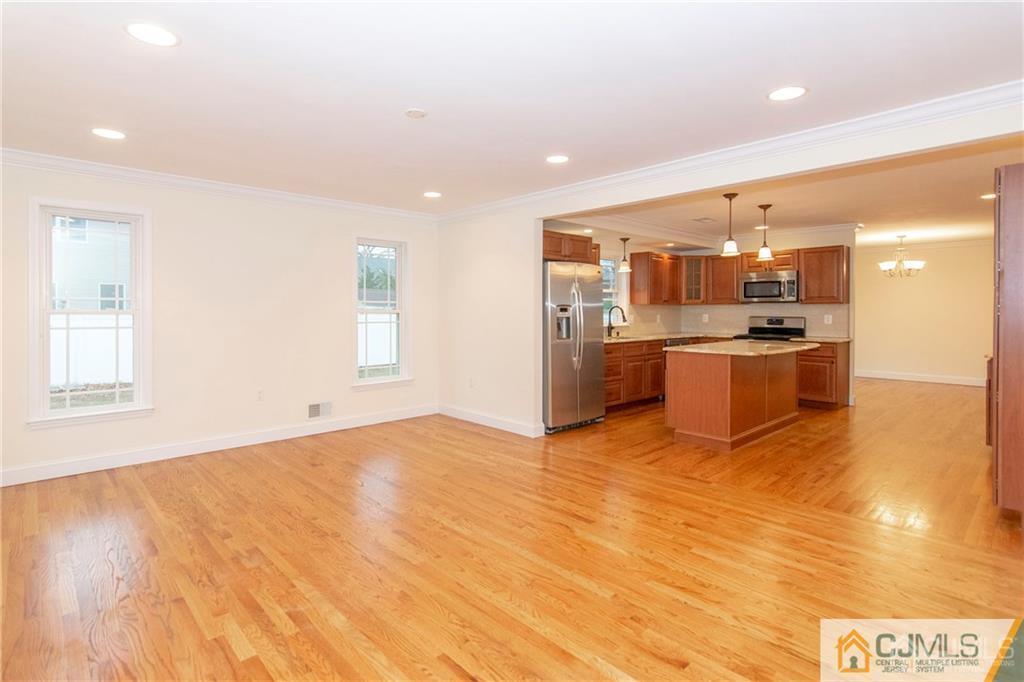 2231 Foster Road Point Pleasant, NJ 08742 - Photo 8 of 25 a view of a kitchen with a sink and wooden cabinets