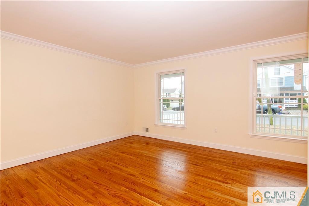 2231 Foster Road Point Pleasant, NJ 08742 - Photo 10 of 25 an empty room with wooden floor and windows