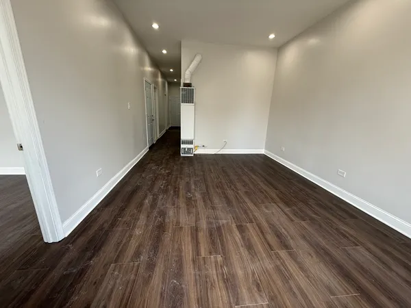 a view of a room with wooden floor