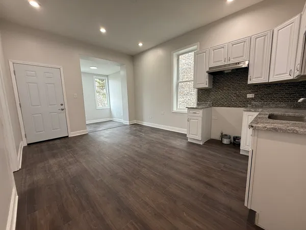 a view of a kitchen with a sink and dishwasher wooden floor