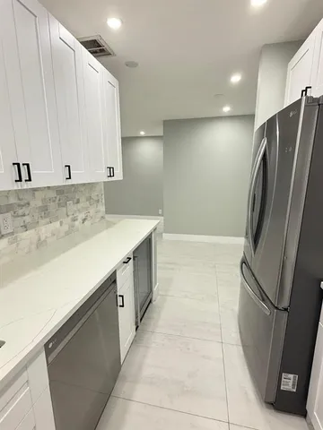 a view of cabinets with stainless steel appliances wooden floor