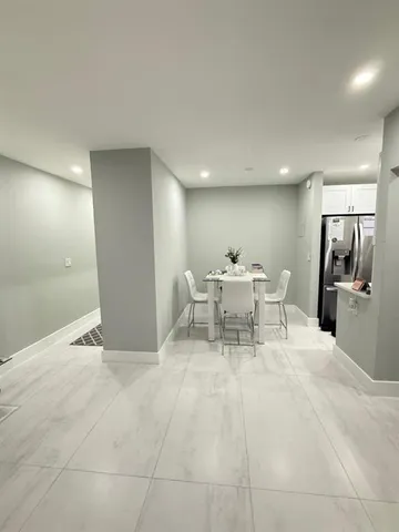 a view of a kitchen with a dining table and chairs