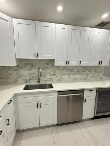 a kitchen with white cabinets