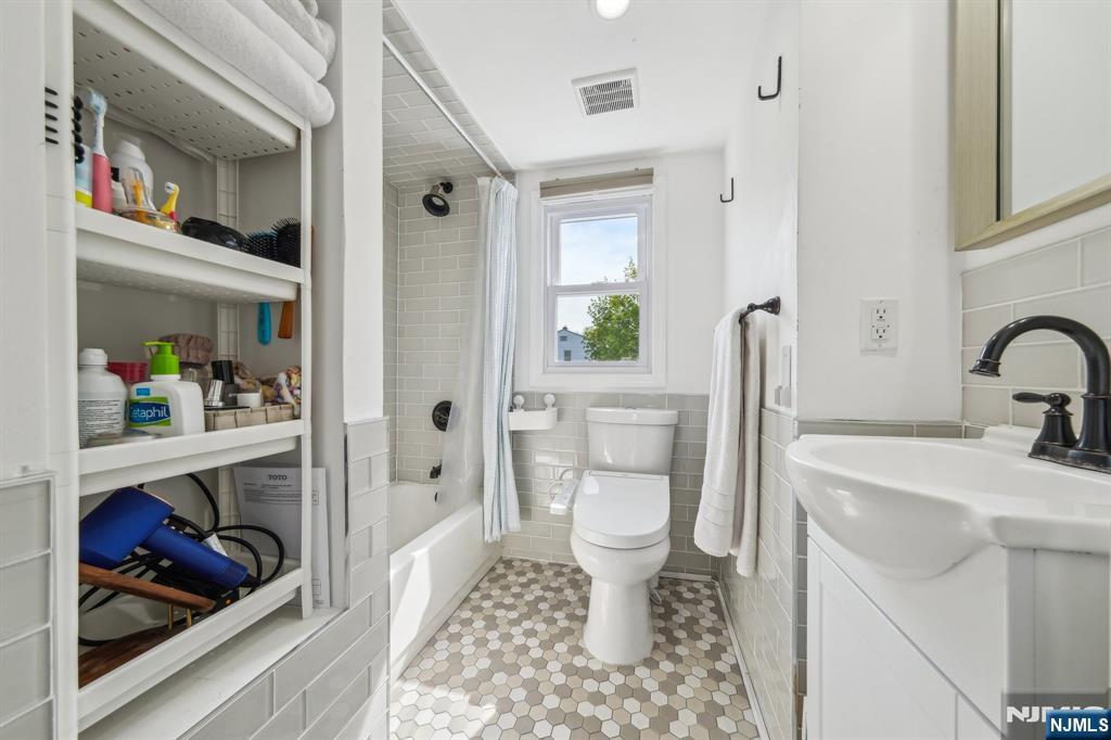 208 Jefferson Avenue Hasbrouck Heights, NJ 07604 - Photo 13 of 20 a bathroom with a sink toilet and a bathtub