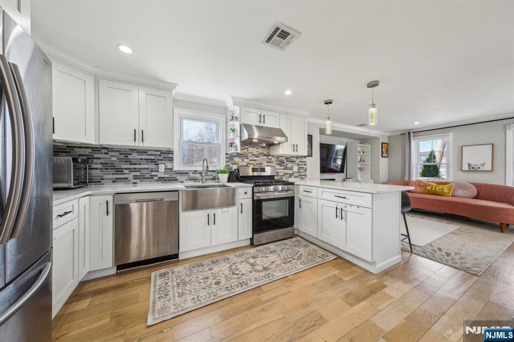 208 Jefferson Avenue Hasbrouck Heights, NJ 07604 - Photo 6 of 20 a kitchen with white cabinets and white appliances