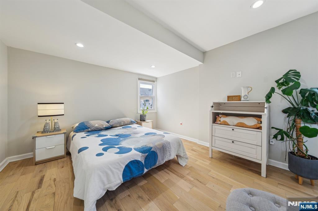 208 Jefferson Avenue Hasbrouck Heights, NJ 07604 - Photo 8 of 20 a bedroom with a bed and a potted plant