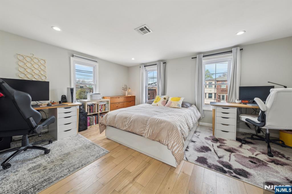 208 Jefferson Avenue Hasbrouck Heights, NJ 07604 - Photo 10 of 20 a bedroom with a bed and wooden floor