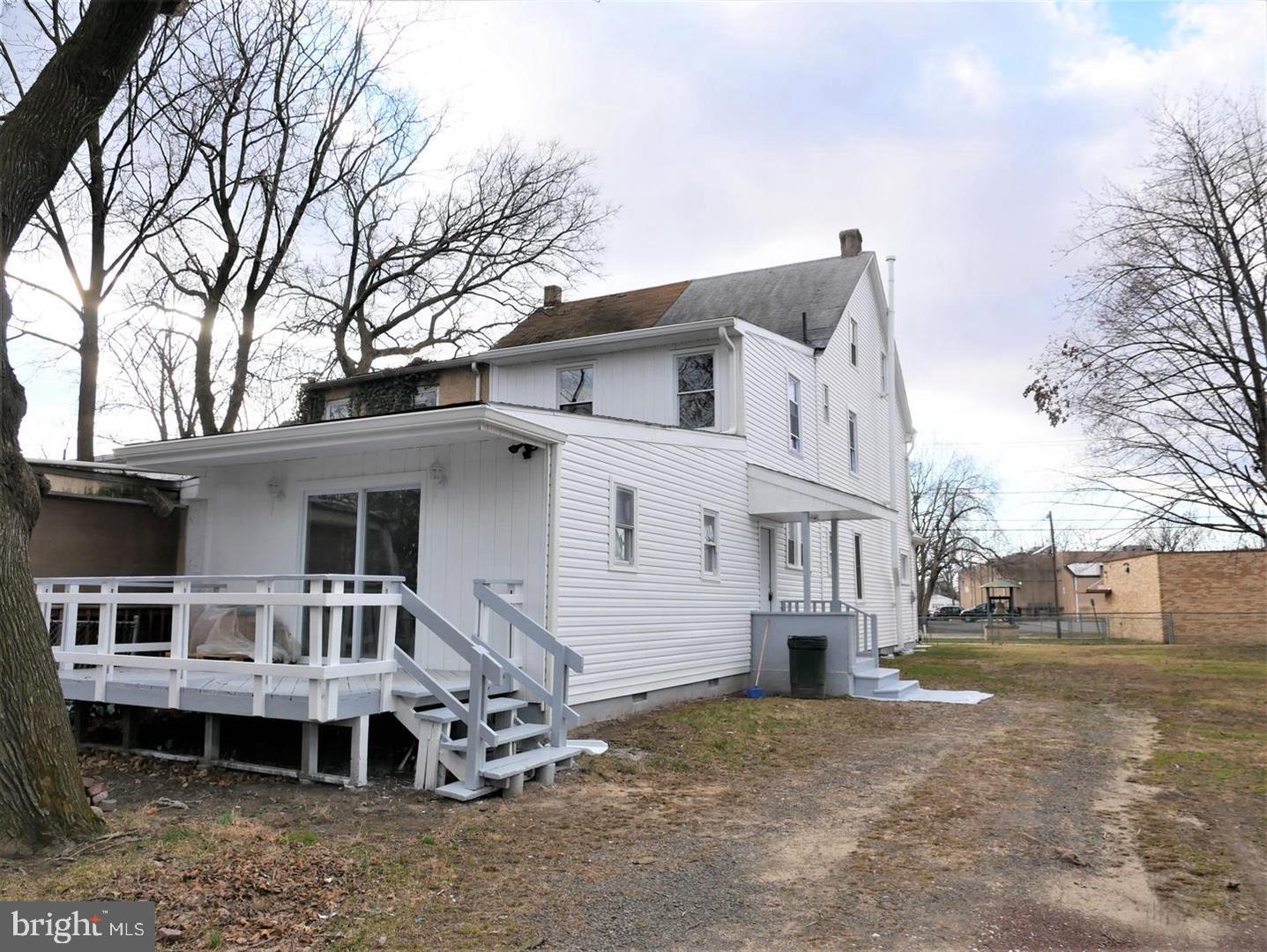 504 Bridge Street Beverly, NJ 08010 - Photo 3 of 13 a front view of a house with a yard