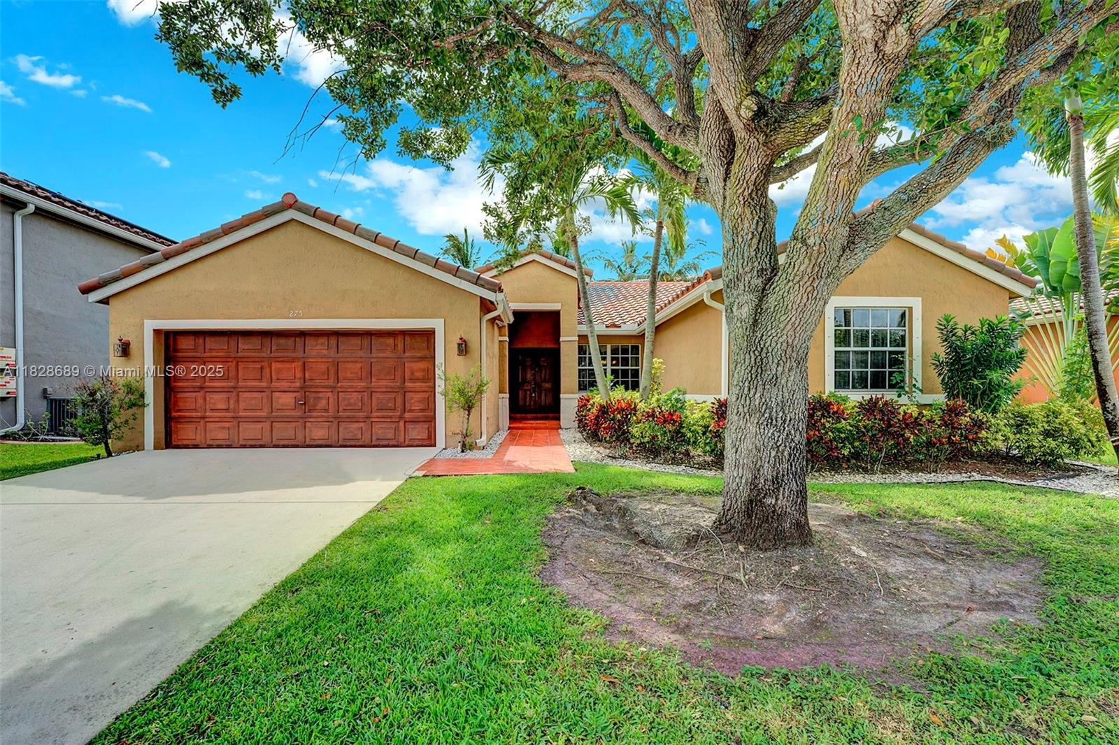 275 Southwest 198th Terrace Pembroke Pines, FL 33029 - Photo 1 of 35 a front view of a house with garden