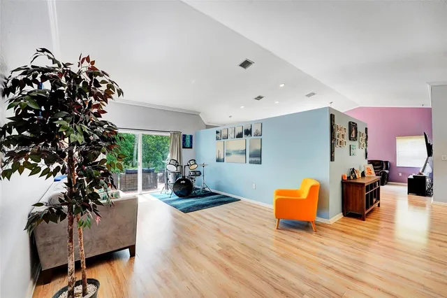 a living room with furniture window and wooden floor