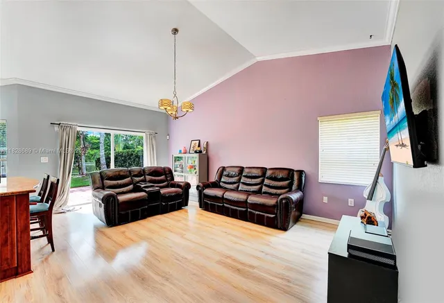 a living room with furniture kitchen and a kitchen view