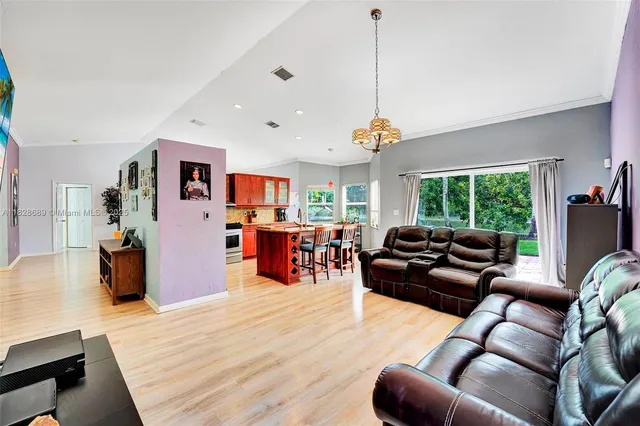 a kitchen with stainless steel appliances kitchen island granite countertop wooden cabinets a sink and a stove