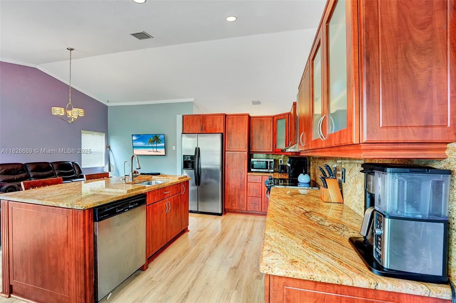 275 Southwest 198th Terrace Pembroke Pines, FL 33029 - Photo 16 of 35 a kitchen with stainless steel appliances granite countertop a stove a sink dishwasher and a refrigerator with wooden floor