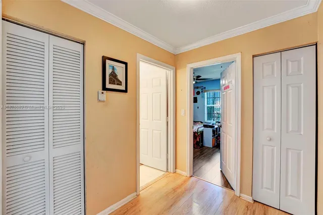 a bedroom with bed and a flat tv screen