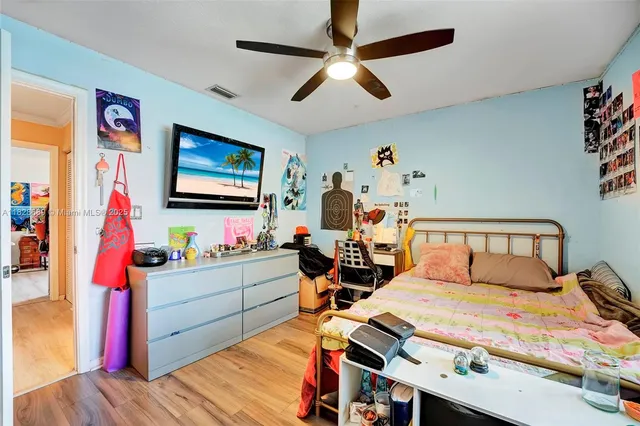 a room with furniture a rug toys and a window