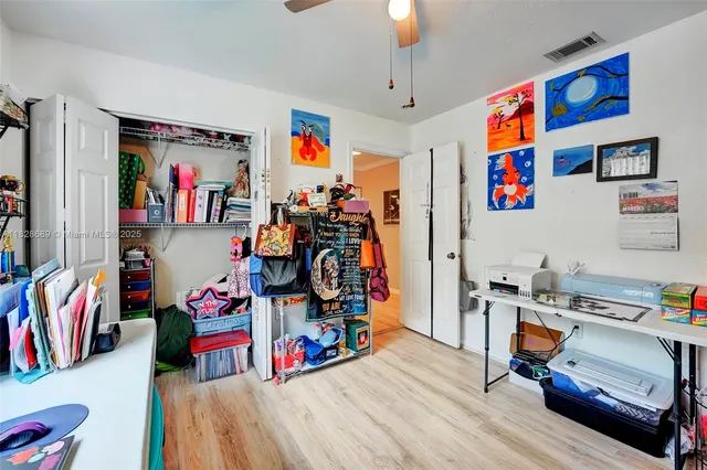 a bedroom with a bed a dresser and chair