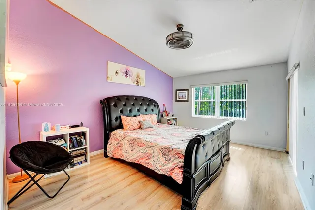 a bathroom with a bathtub a double vanity sink a window and mirror