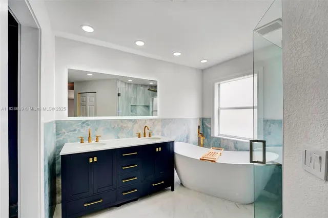 an aerial view of a house with a yard and lake view