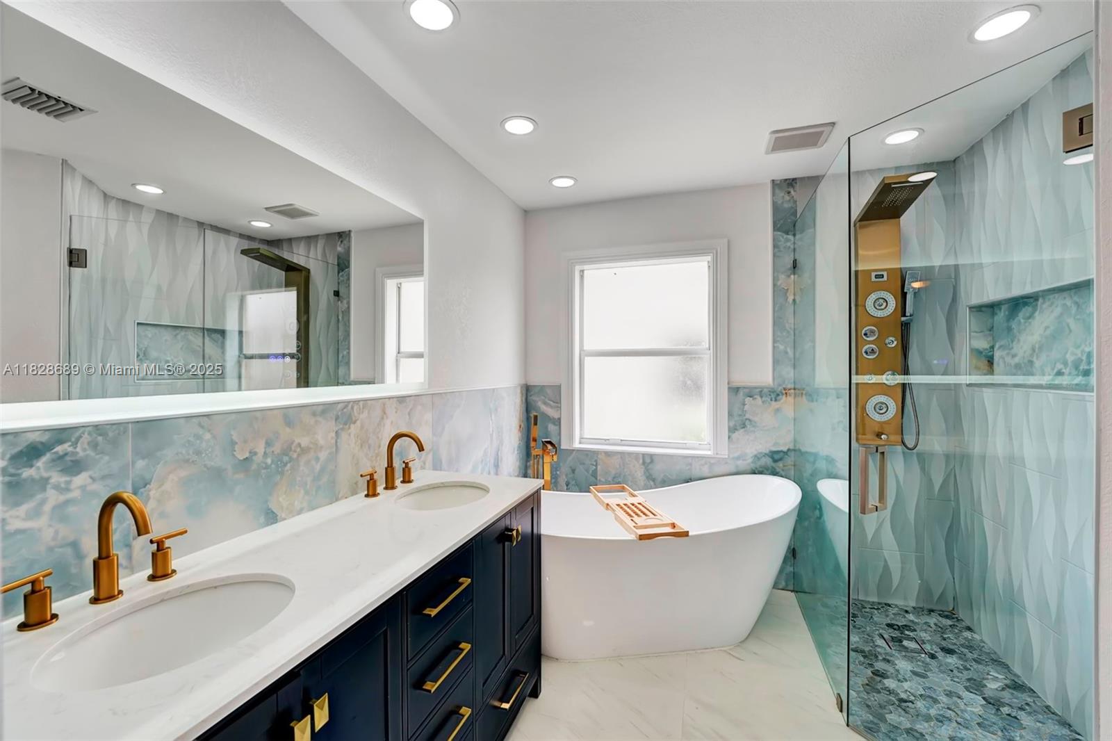 275 Southwest 198th Terrace Pembroke Pines, FL 33029 - Photo 28 of 35 a bathroom with a sink double vanity and a bathtub