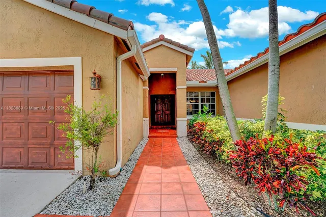 a view of a house with potted plants