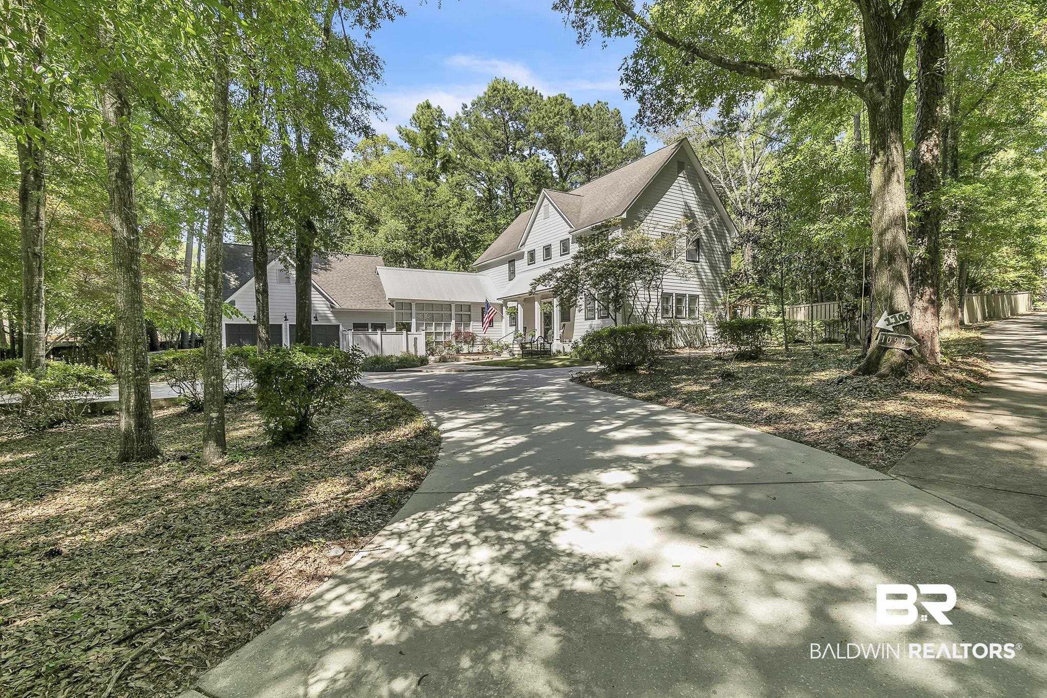 1106 Old County Road Daphne, AL 36526 - Photo 5 of 66 Spacious concrete driveway leading to a multi-story residence with light-colored siding and a gabled roof