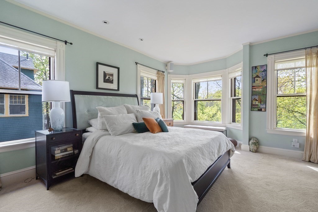 53 Oxford Road Newton, MA 02459 - Photo 16 of 32 a bedroom with a bed next to a window and a larger closet