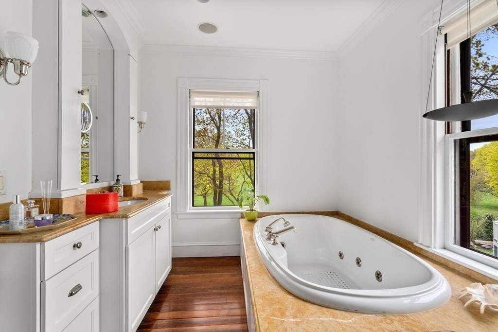 53 Oxford Road Newton, MA 02459 - Photo 19 of 32 a bathroom with a tub sink and mirror