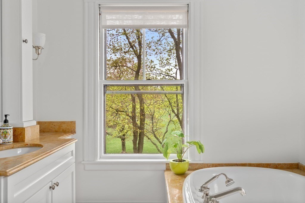 53 Oxford Road Newton, MA 02459 - Photo 20 of 32 a bathroom with a sink and a window