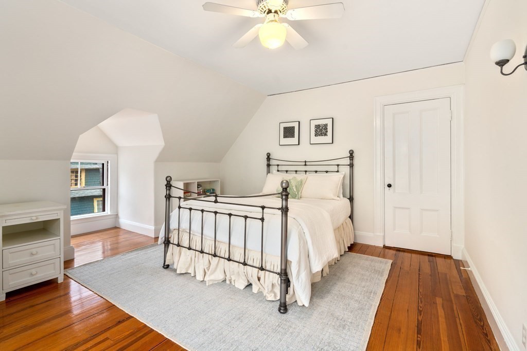 53 Oxford Road Newton, MA 02459 - Photo 23 of 32 a bed room with a bed and a chandelier