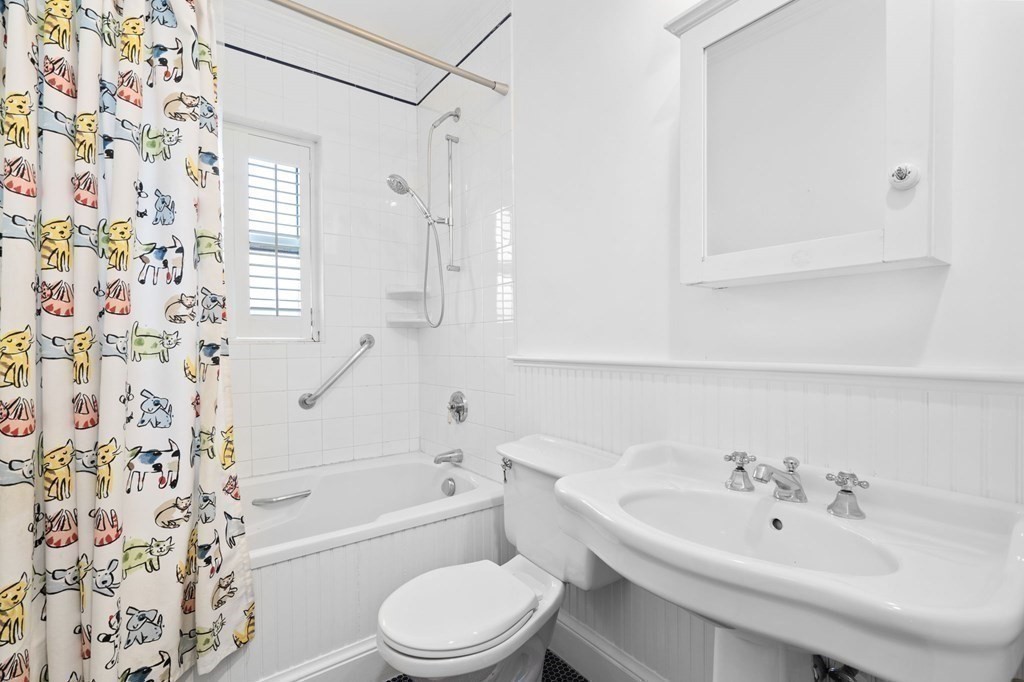 53 Oxford Road Newton, MA 02459 - Photo 25 of 32 a bathroom with a bathtub shower sink vanity and toilet