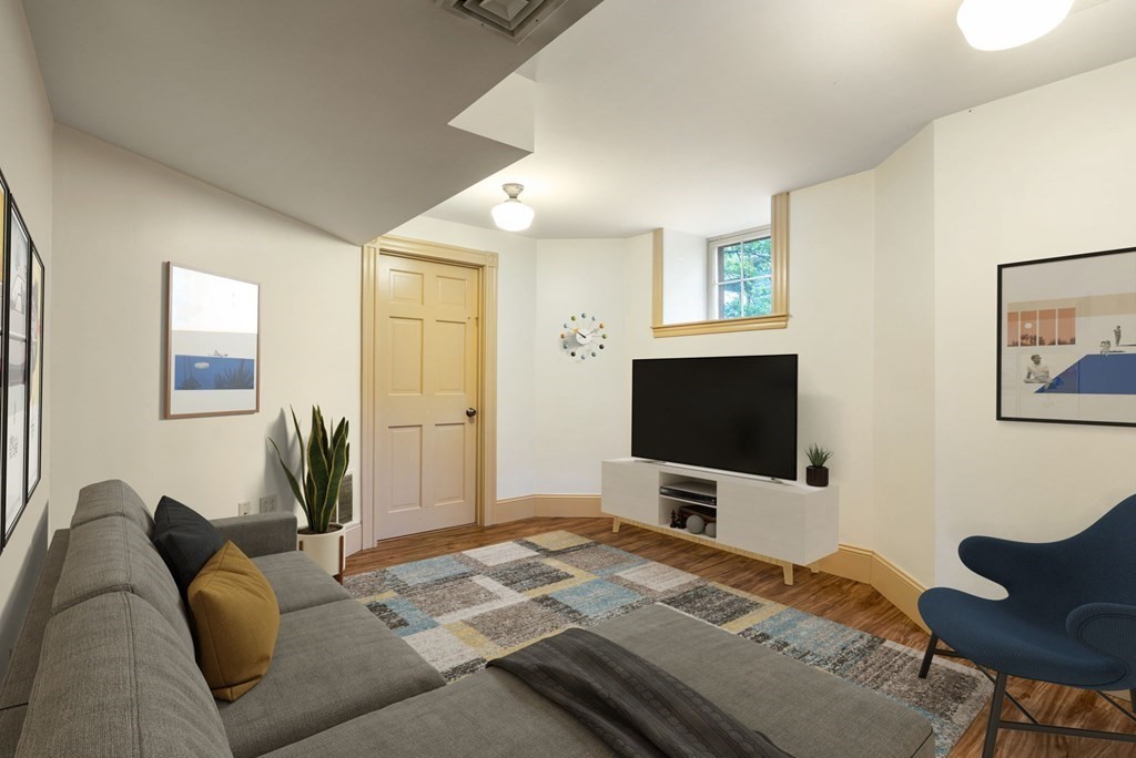 53 Oxford Road Newton, MA 02459 - Photo 26 of 32 a living room with furniture and a flat screen tv