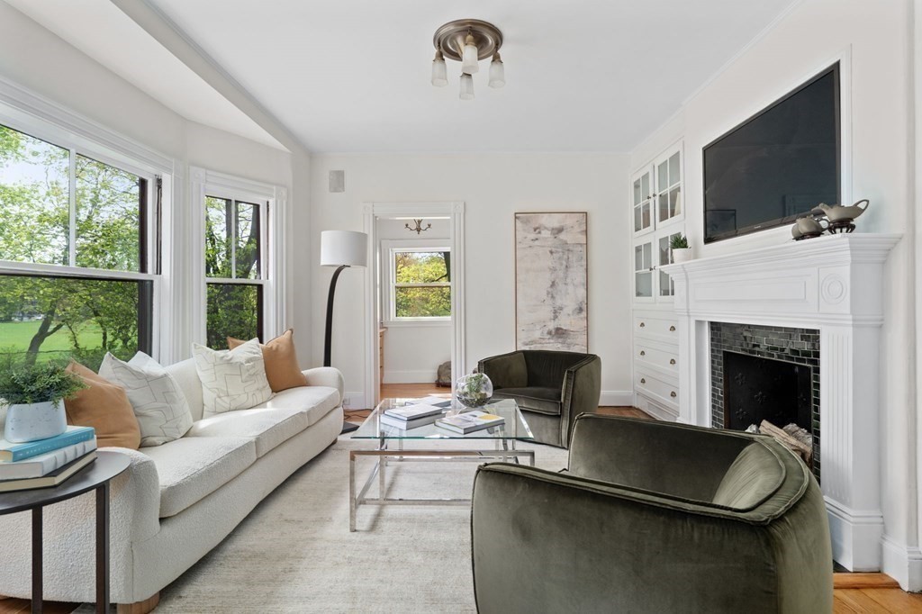 53 Oxford Road Newton, MA 02459 - Photo 9 of 32 a living room with furniture a flat screen tv and a fireplace