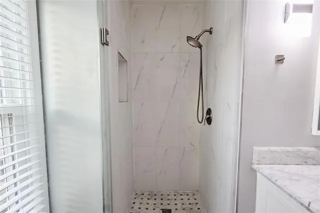 a bathroom with a granite countertop shower