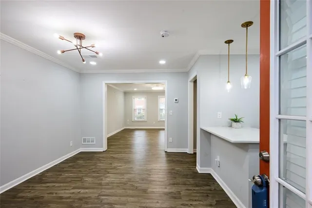 a view of a hallway with wooden floor and staircase