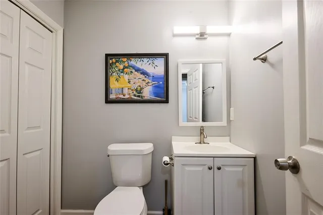 a bathroom with a toilet a sink and mirror
