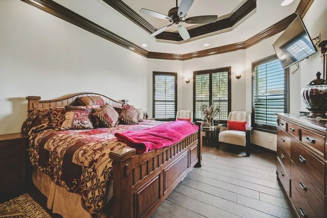 a bedroom with bed and wooden floor