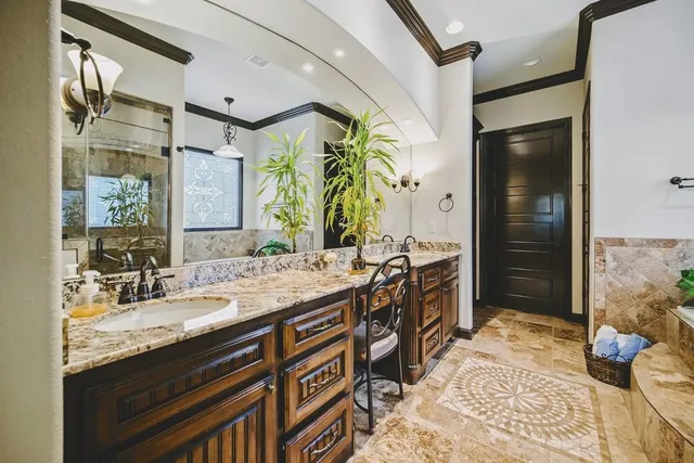 a spacious bathroom with a granite countertop sink and a mirror